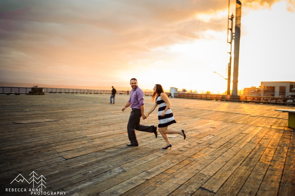 Running on boardwalk in Downtown Tacoma Engagement Photo